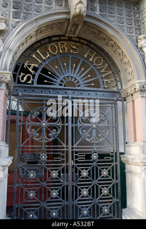 Arched entrance of the 'Sailor`s Home and Chapel' closed off by Iron gates along Dock Street in Dundee, UK Stock Photo